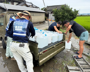  Volunteers unloading water containers from a truck.