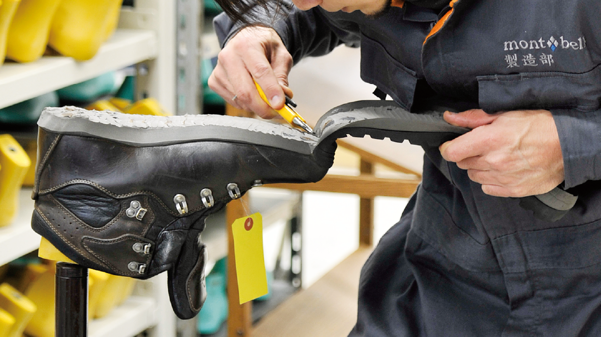 Manually removing the outsole of hiking boots.