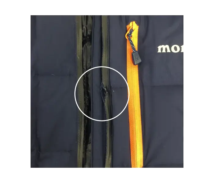Photo with circled area where zipper coil is damaged.