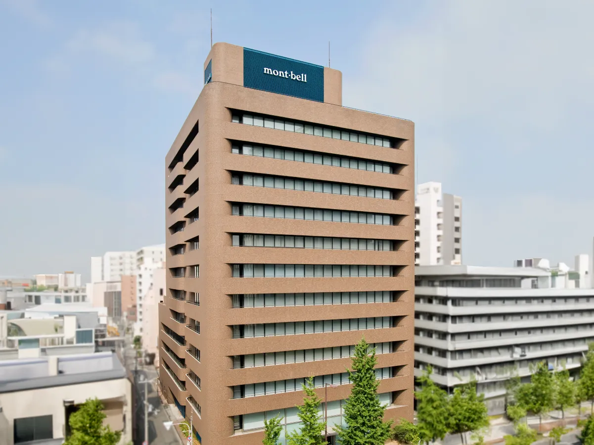 Exterior view of the Montbell headquarters building. A 12-story building with brown exterior walls.