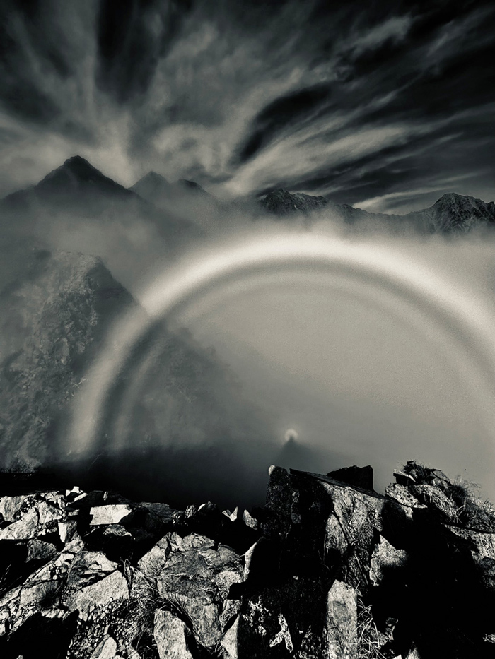 A photograph of the Brocken spectre phenomenon as seen from a mountain ridge