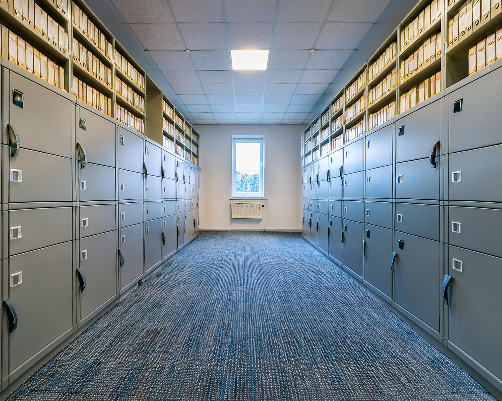 A room with neatly arranged filing cabinets and files.