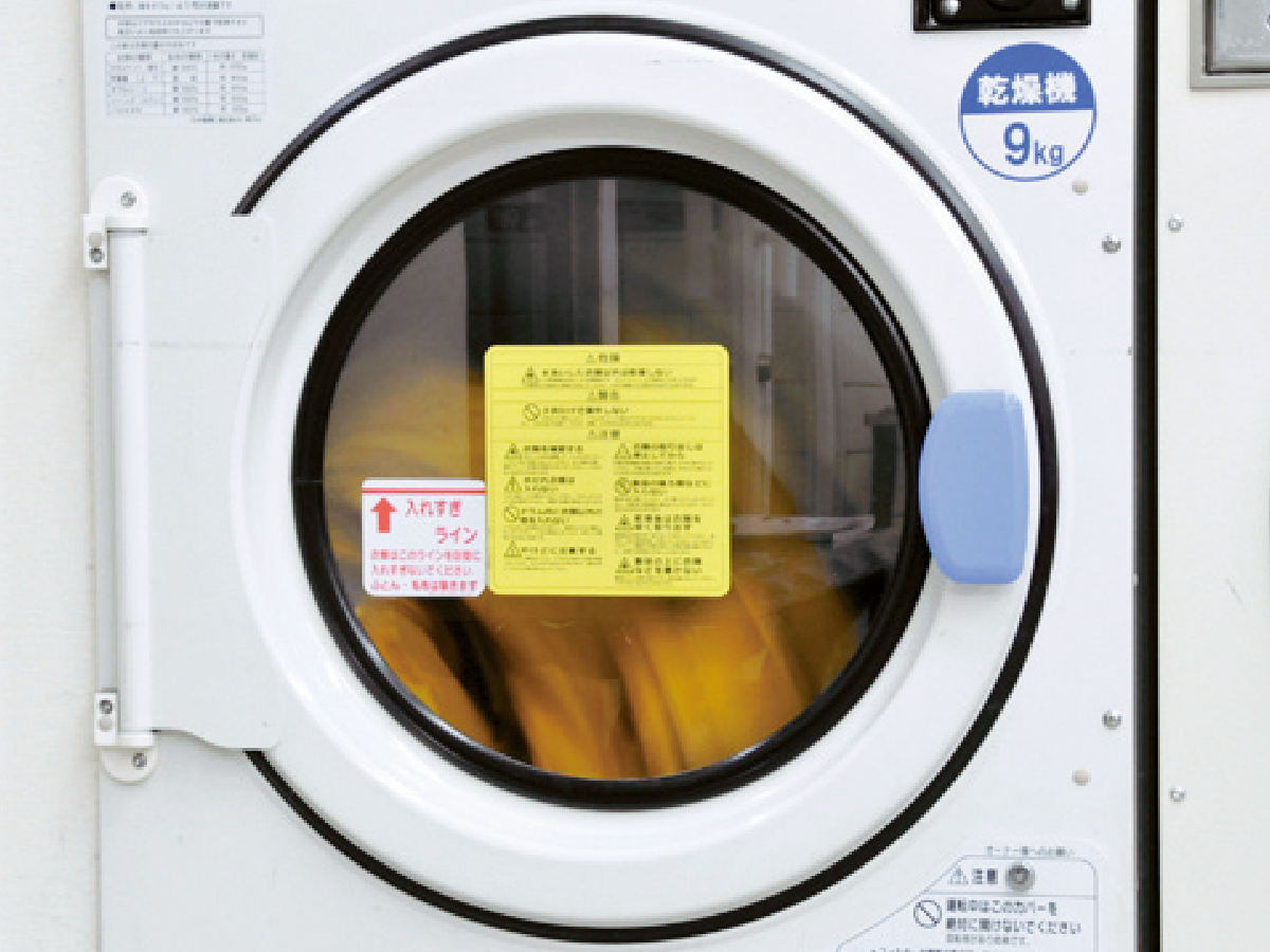 A photo of drying rainwear in a dryer