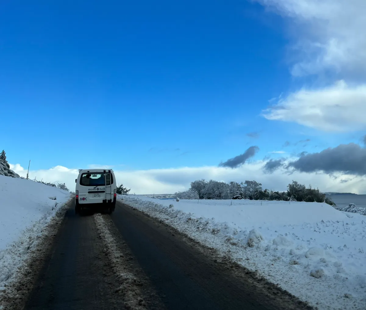 An Outdoor Gientai vehicle driving on a snowy road.