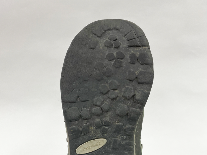Hiking boot outsole before repair: Overall wear on the outsole.
