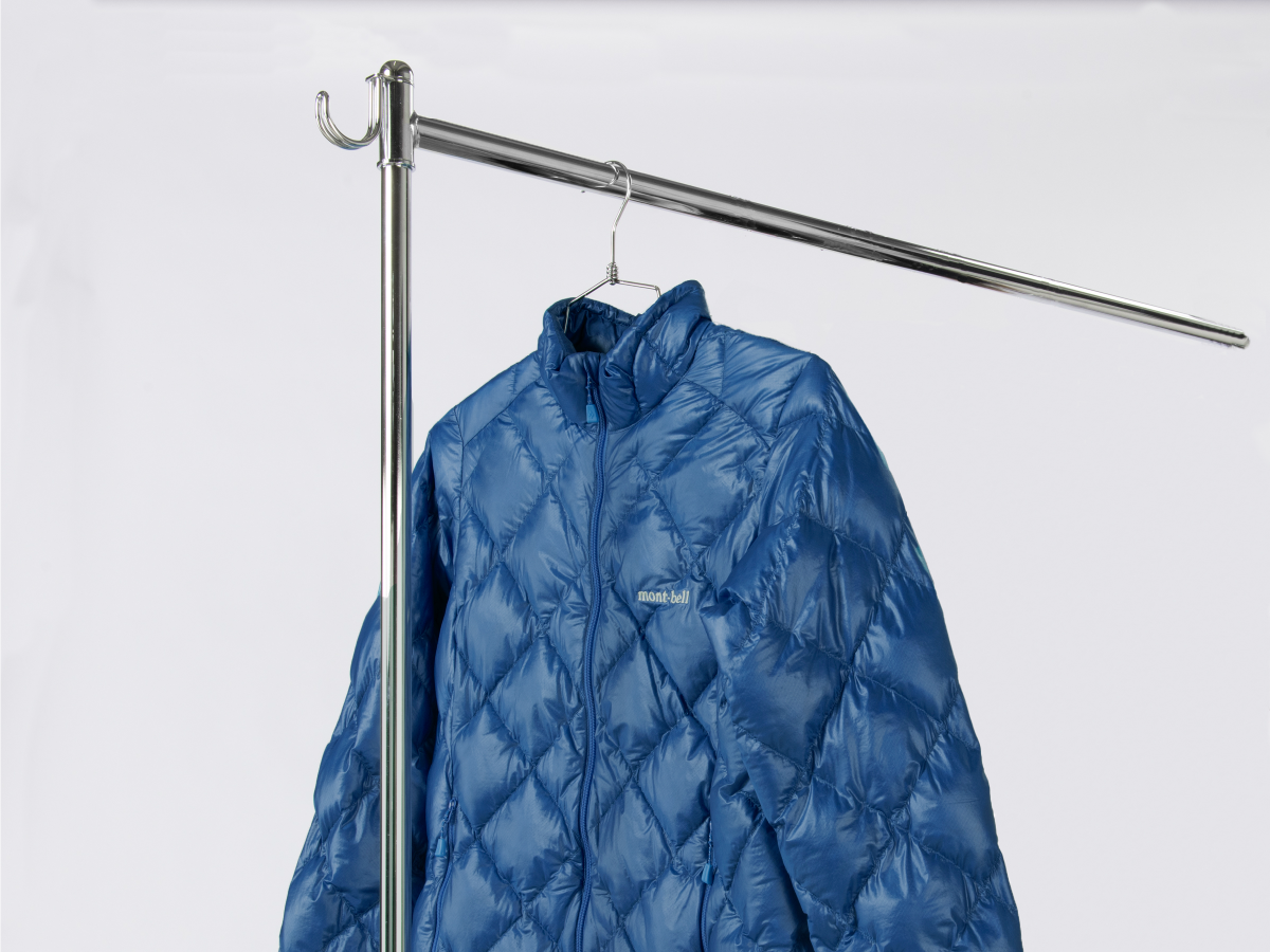 Down outerwear hanging to dry on a hanger