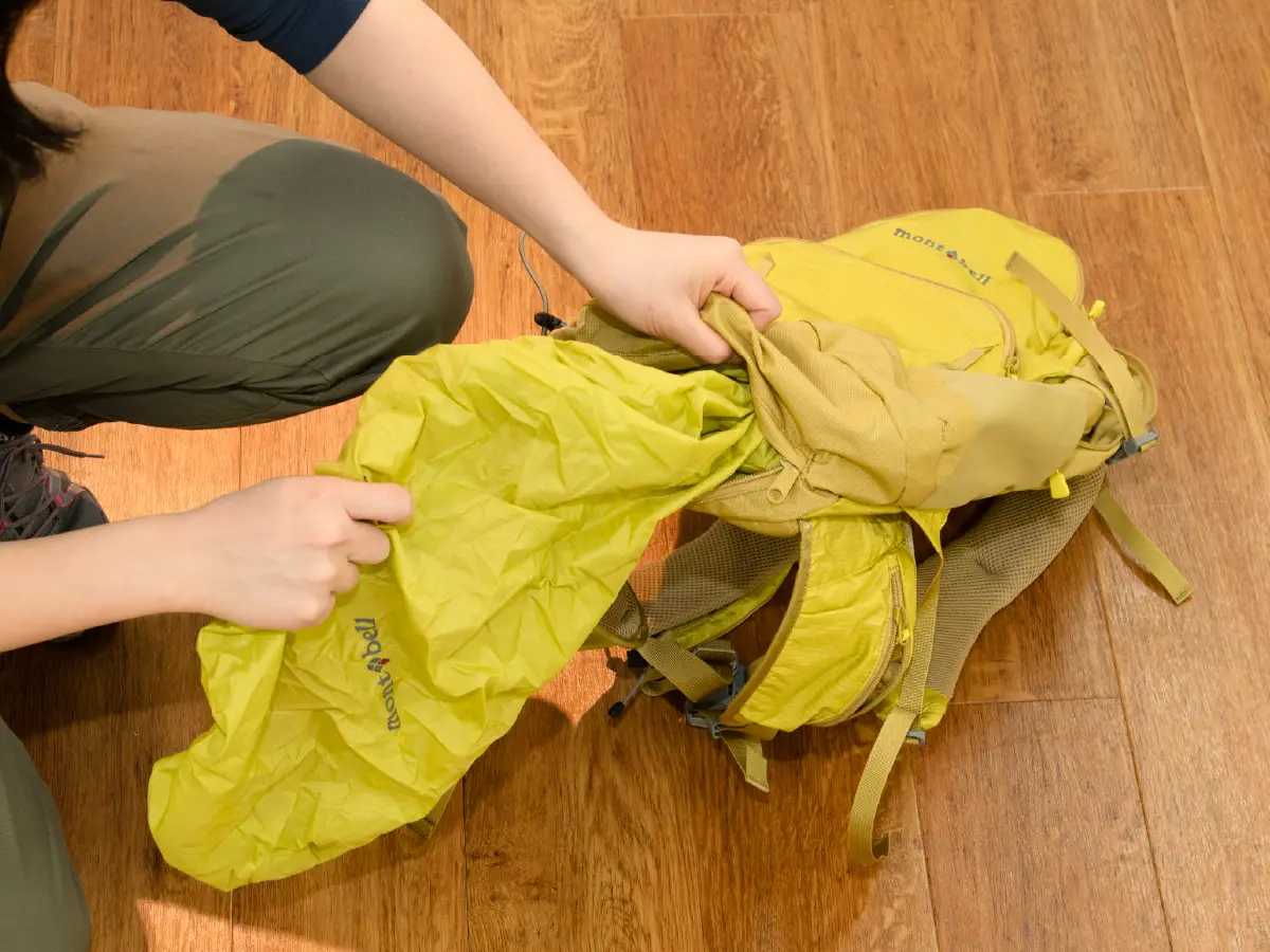 Photo of pack cover being removed from backpack