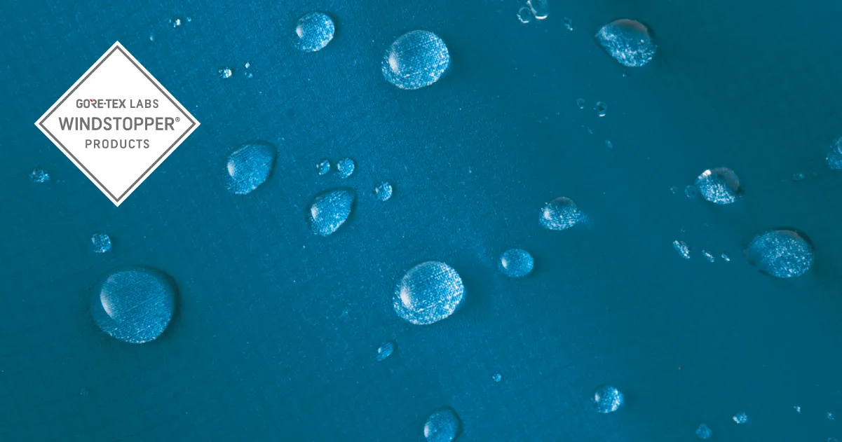 WINDSTOPPER fabrics by GORE-TEX LABS logo and photo of blue fabric repelling water