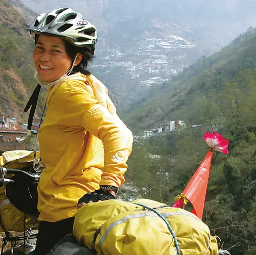 Ms. Seal Emiko traveling with luggage loaded on her bicycle's cargo rack