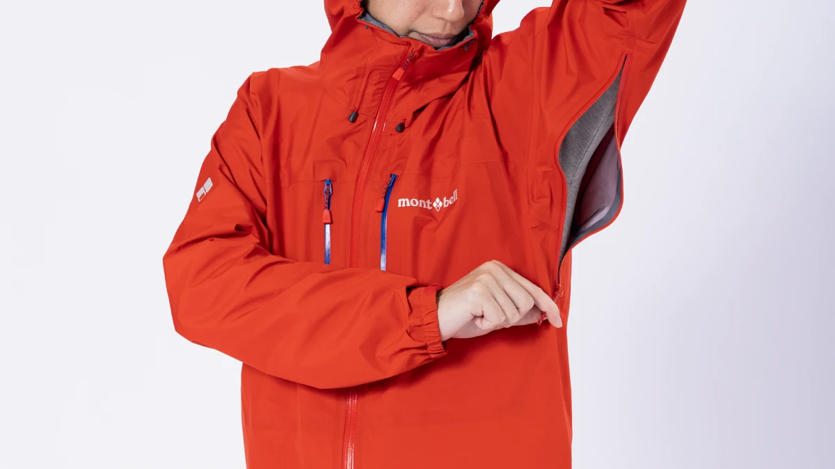 A photo showing arms raised with pit zips (zippers attached to the armpit area) open