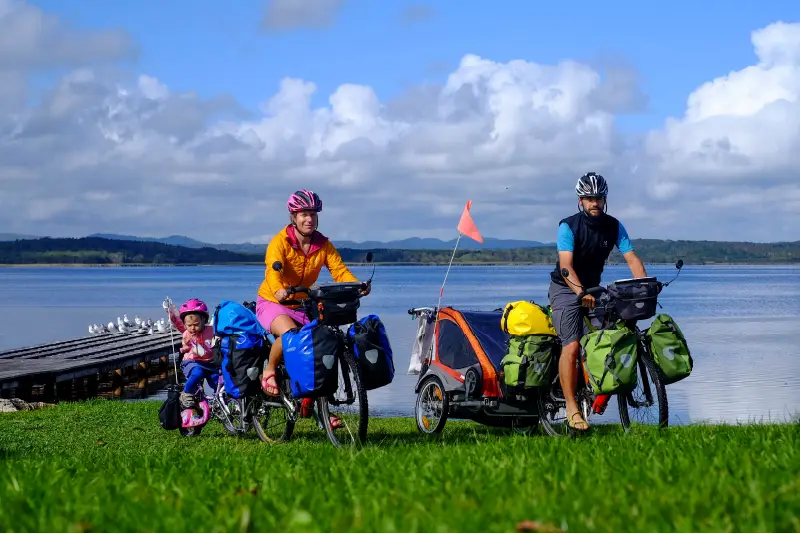 Pasch family riding bicycles along the coast