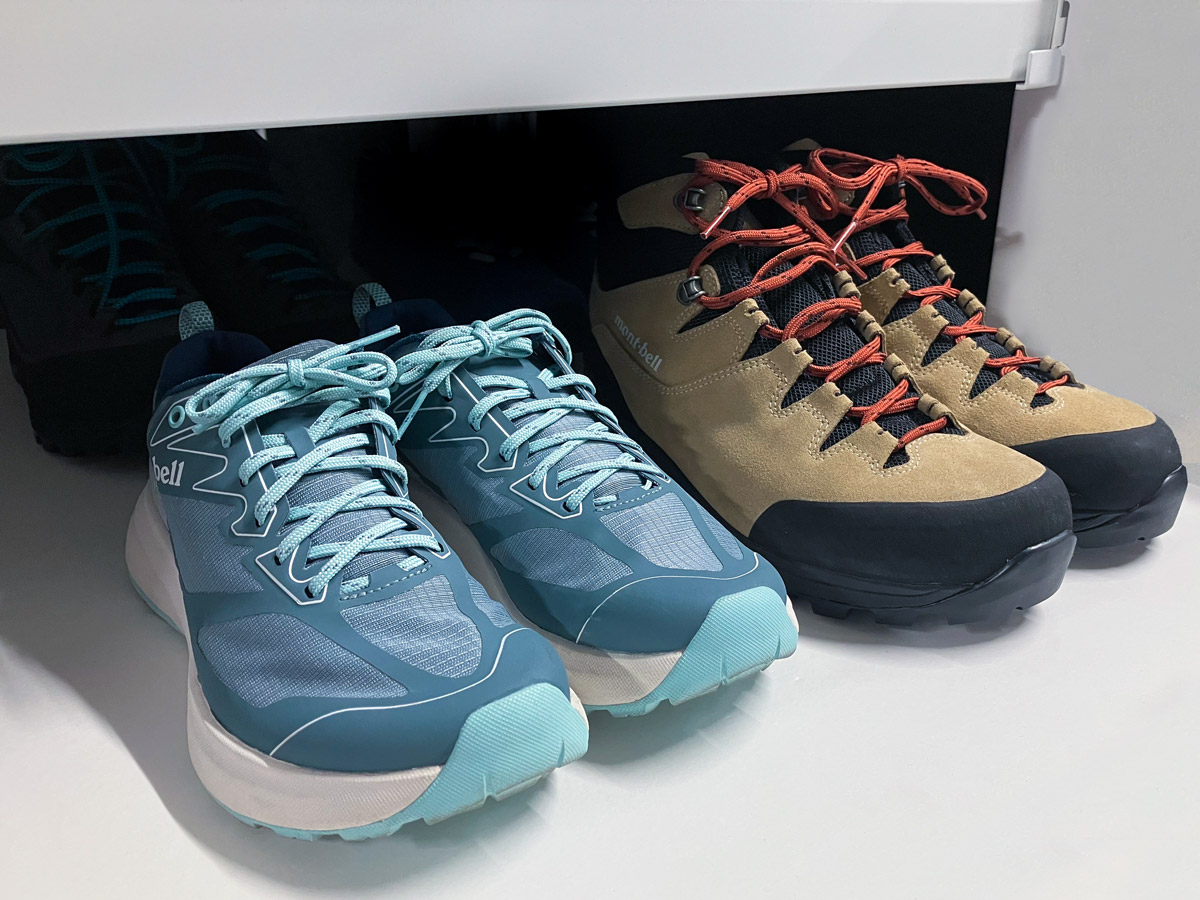 A view of two pairs of hiking boots being stored on a shoe rack.