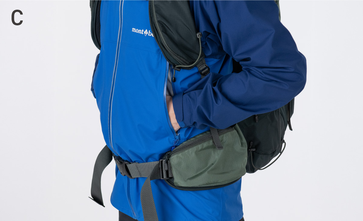 An example of how it looks when worn with a backpack. The pocket opening is positioned so as not to interfere with the harness or other equipment.